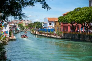 Scenic view of Malacca River with colorful buildings and boats, showcasing the vibrant atmosphere of this historic Malaysian waterway.