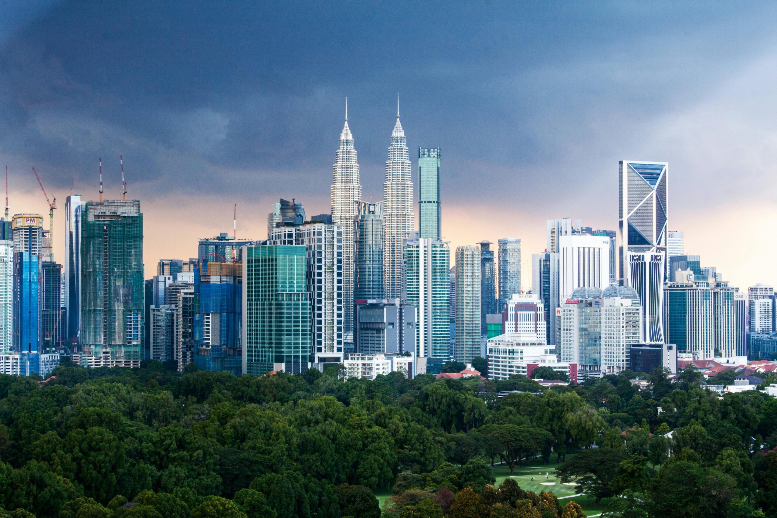 A stunning view of the Petronas Twin Towers in Kuala Lumpur, Malaysia, illuminated against the night sky.